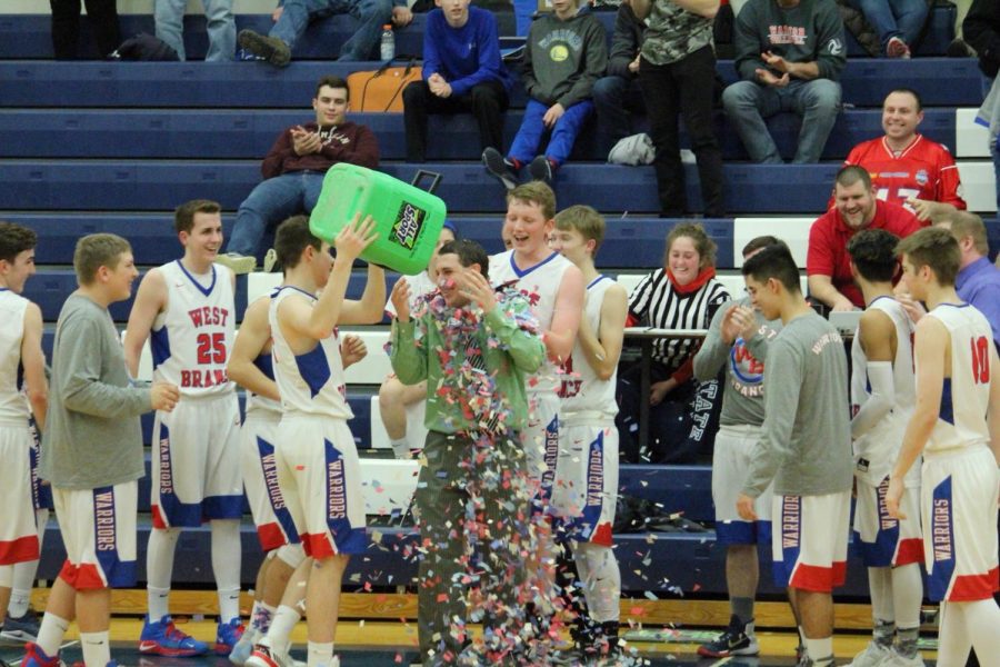 The+team+celebrates+with+Coach+Clark+after+the+game.