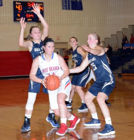 Photo courtesy of Jaclyn Yingling Herring gets rid of the ball as two opponents defend her.