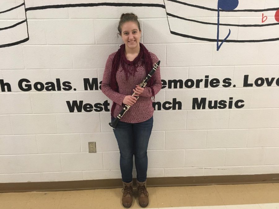 Regional Band Attendee Rachel Heitsenrether standing with her clarinet outside of the bandroom.