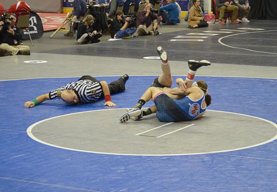 Tyler Denochick attempting to pin opponent