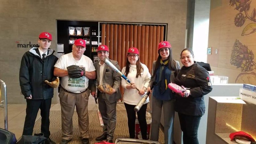 Gary Miller poses with the Chilean hotel lobbyists and their newly acquired baseball equipment