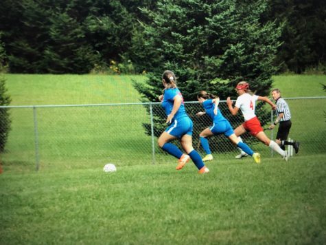 Lady Warriors Trinity Prestash and Eleyna Hanslovan chase down a loose ball.