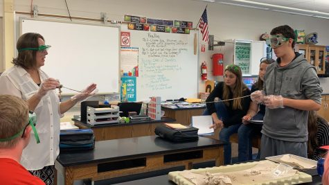 Mrs. McGonigal and Wyatt Laird showing the length of the small intestine of a fetal pig.