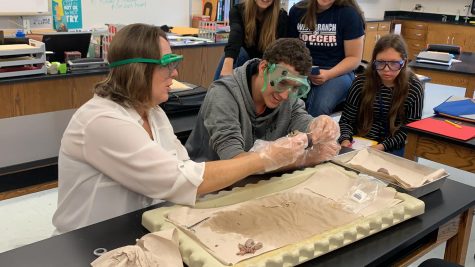 Mrs. McGonigal and student Wyatt Laird separating the small intestine of a fetal pig.
