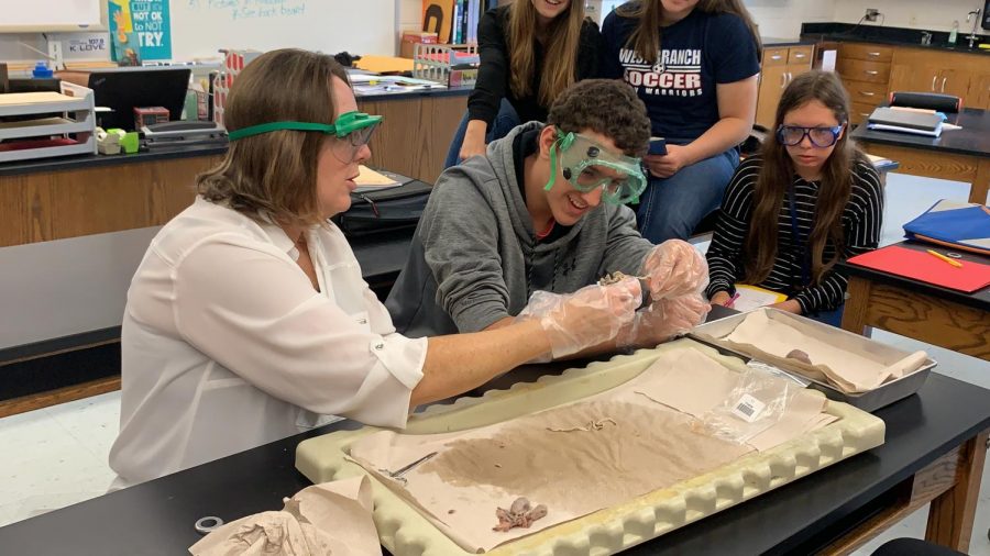 Mrs.+McGonigal+and+student+Wyatt+Laird+separating+the+small+intestine+of+a+fetal+pig.