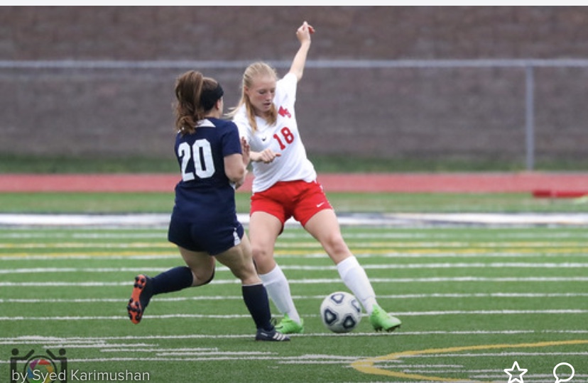Madison Kephart gains control of the ball in front of a PO attacker.