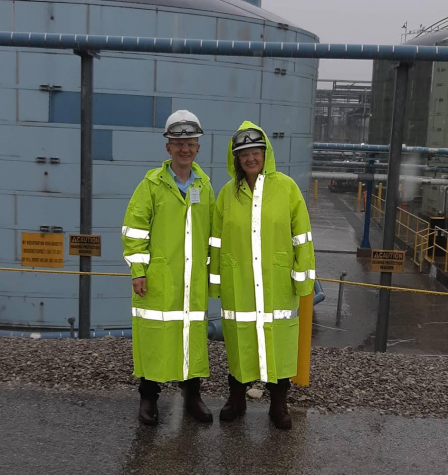 Barbara Buck and a co-worker smile for a photo wearing fluorescent and reflective yellow jackets.