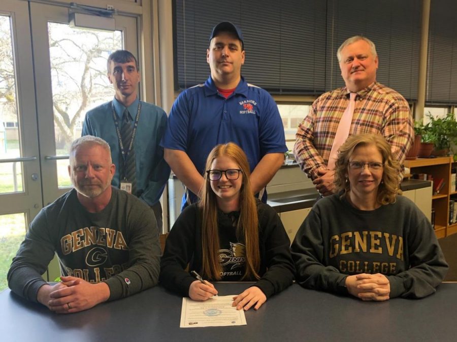 Elishea Reed signed her leter of intent to play softball at Geneva. Pictured with her are her parents, Mr. Williamson, Head Coach Dan Betts, and Mr. Holenchik.