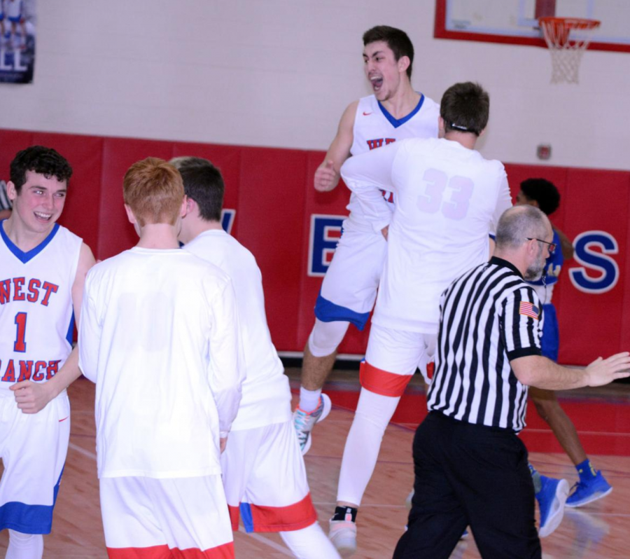 Ayden Gutierrez celebrates with Kyle Kolesar as Camden Kopchik also celebrates the Warriors victory against Mount Union.