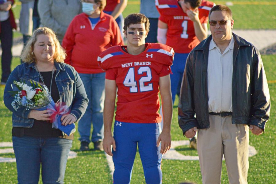 Noah Hoffner and parents during senior recognition ceremony
