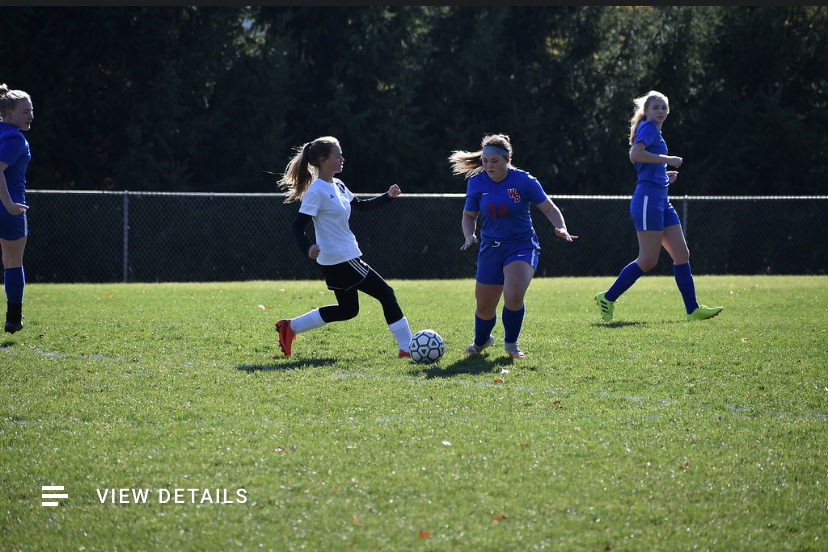Lady Warriors centerback Eleyna Hanslovan dribbles the ball past a northern Bedford defender. Hanslovan helped to earn another shutout for the Lady Warriors.