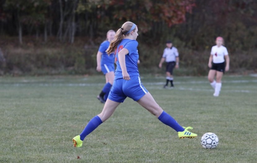 Anna Diviney dribbles the ball up the field looking for a pass.