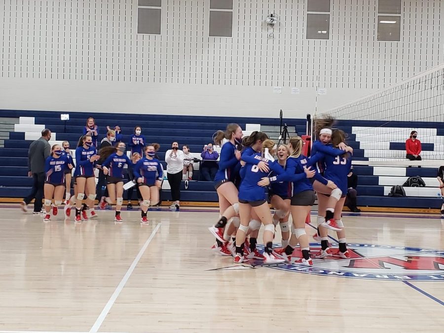 The Lady Warrior Volleyball team celebrate their district semi-final victory over Homer Center.