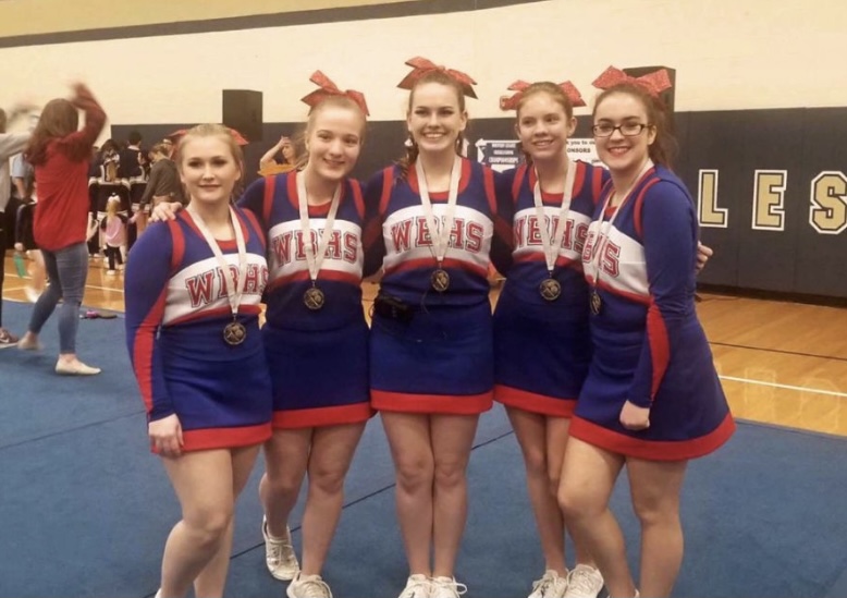 Rachael Kyler posing for the camera with her cheer squad.