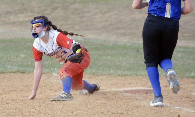 Sarah Betts stretches for a ball at first base to get an out for her team.