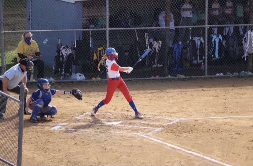 Meghan Cantolina finishing through a big swing at the opponents plate.