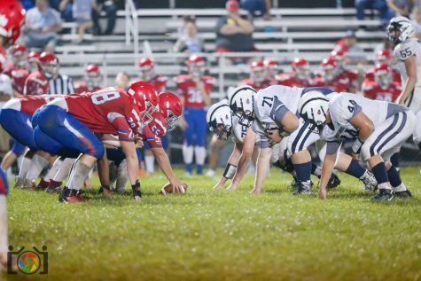 The West Branch Warriors and the Philipsburg-Osceola Mounties line up before a play.