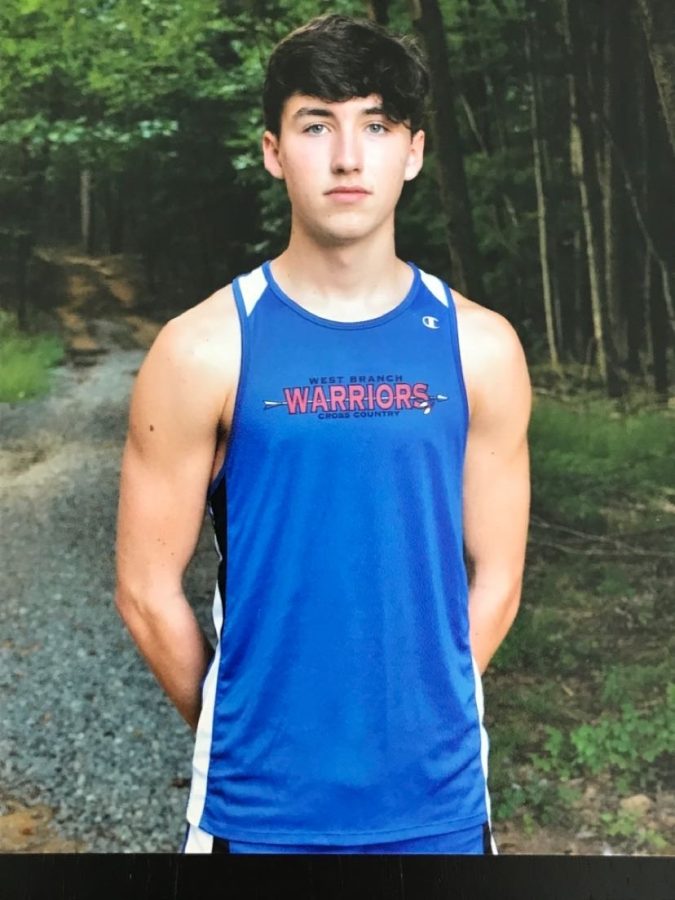 Sage Carr stands tall in his cross country photo.
