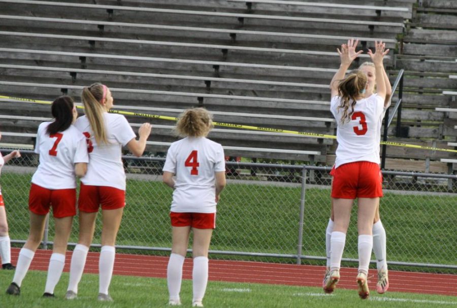 Lauren Timblin and Emily Parks jump to high five during the starting lineups prior to the game.