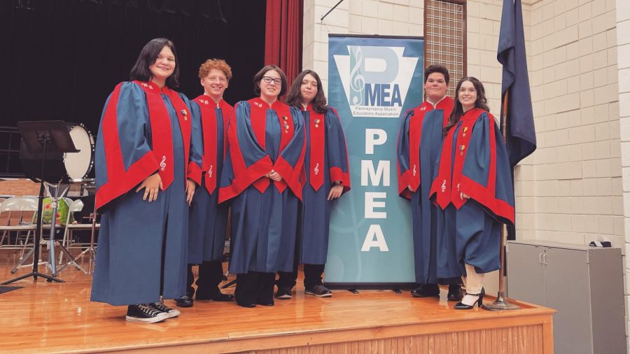 The District Choir attendees pose for a picture by the PMEA banner. From left to right: Joelle Fletcher, Matt Eirich, Maya Rabb, Braeden Salter, Noah Fry, and Carrie Fuller.