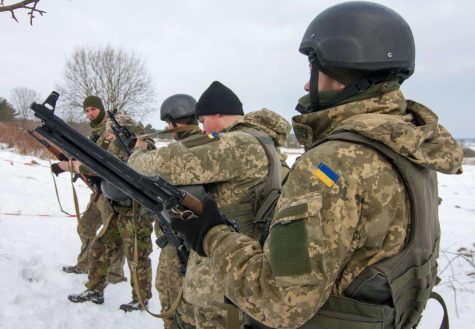 Ukrainian soldiers line up to complete a training exercise at the Yavoriv Combat Training Center.