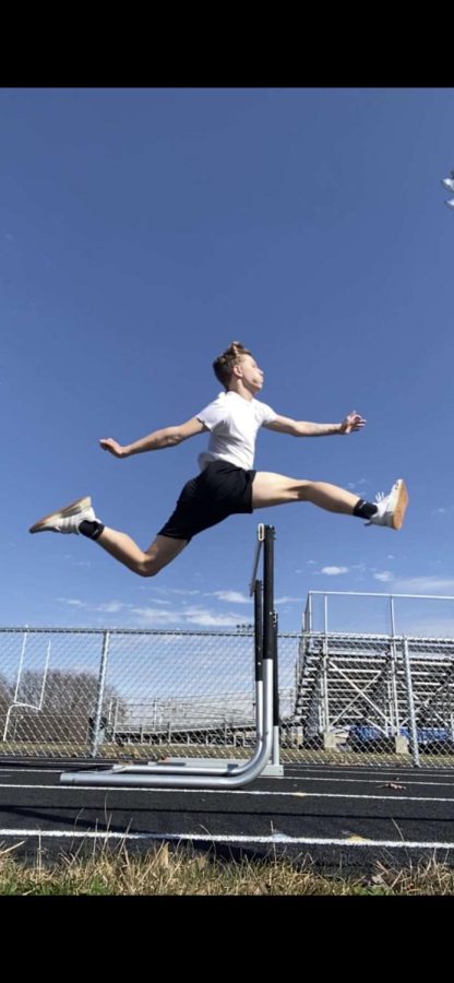 Shae practices jumping hurdles on the practice track at L.T. Drivas Memorial Field.