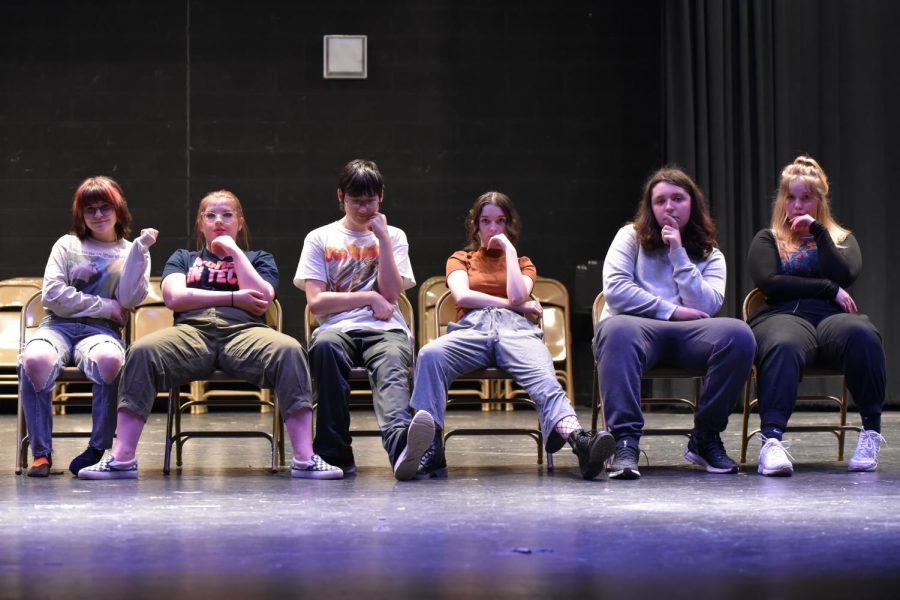 The Addams Family practicing the dinner scene. From left to right: Bailey Wooster, Raven Myers, Doug Howe, Carrie Fuller, Braeden Salter, Evelyn Lloyd.