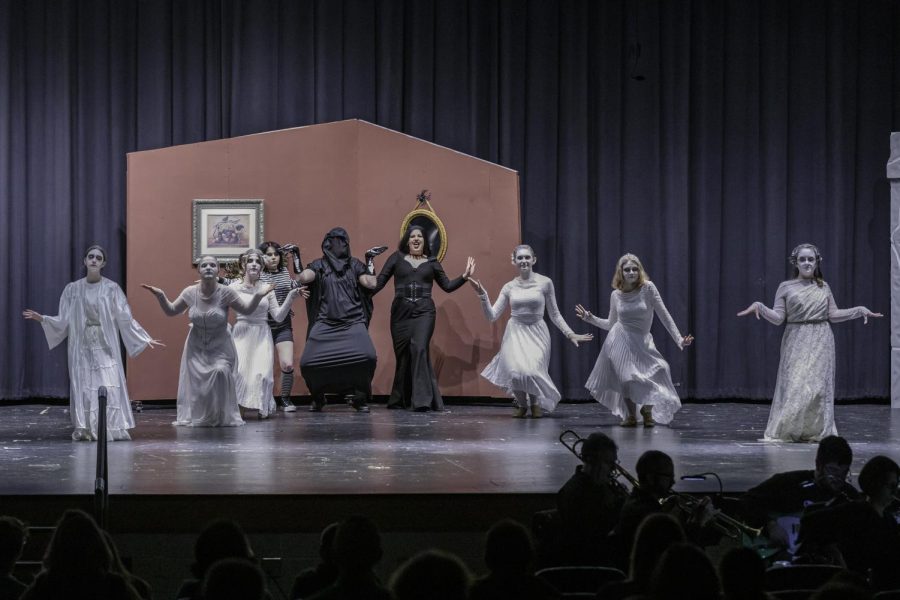 Raven Myers as Morticia performing “Just Around the Corner” with the ancestors.