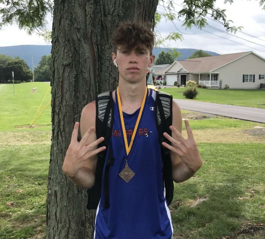 Noah Ryder poses with his medal after finishing 12th overall for the boys’ race.