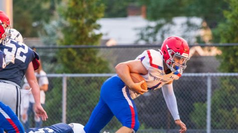 Tyler Biggans topples over defenders to score against PO in the 2022 season opener.