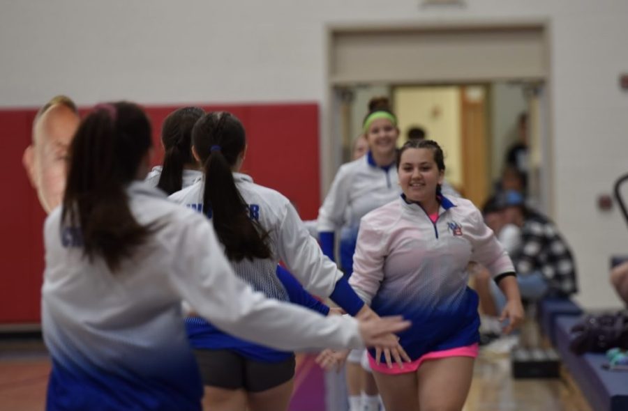 The Lady Warrior Volleyball Team running out for their pregame warm-ups.