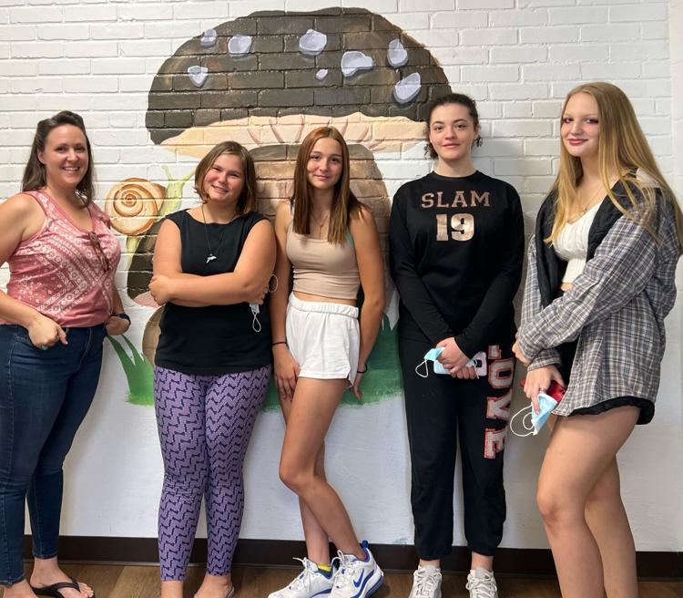 Ms. Steffan and the students pose in front of one of the murals. Pictured left to right: Rachel Steffan, Ashleigha Grossi, Breanna Rinehart, Shaela Gillen, and Carly Watro.