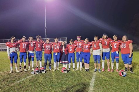 The football team and Kayleigh Smeal pose for a picture after the game.