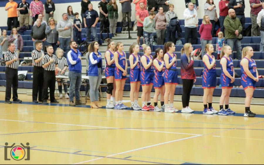 The Lady Warriors stand for the national anthem before their game against Philipsburg-Osceola.