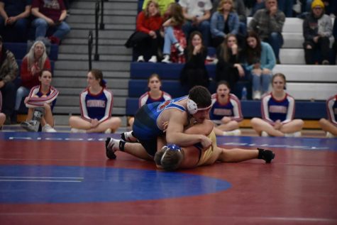 Junior Austin Kerin takes down an opponent during a match earlier this season.