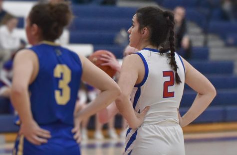 Hannah Betts lines up to rebound, while teammate Erin Godin shoots a free throw.