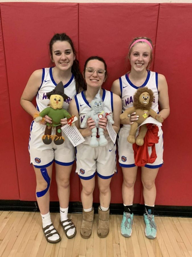 The three seniors stand with their gifts from Coach Koleno.