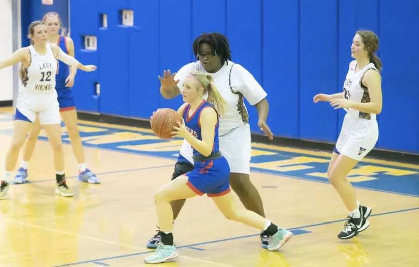 Senior Emily Parks passes the ball as Minyhah Easterling guards her.