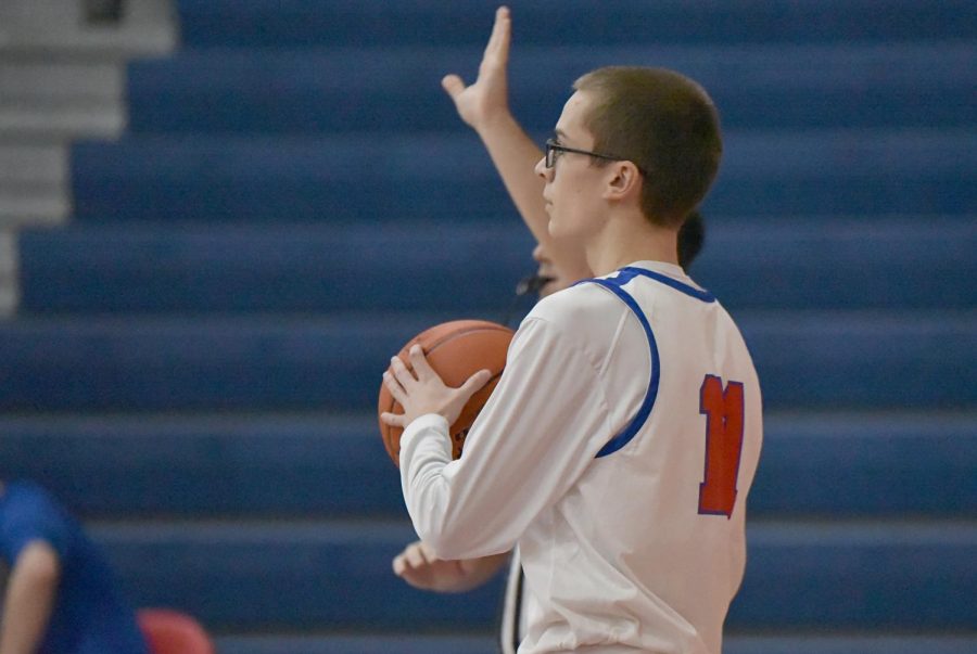 Zack McGonigal prepares to make an inbound pass to his teammate at a home game against Harmony. 