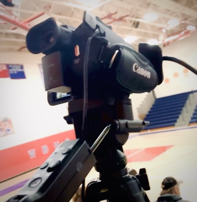 Live-stream+technicians+broadcast+a+girls+basketball+game+in+the+high+school+new+gym.