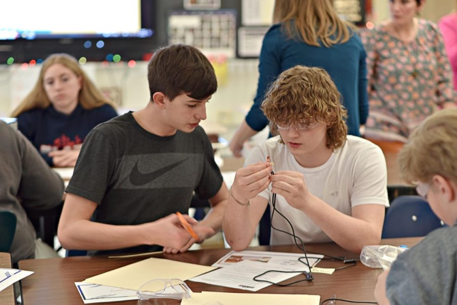 Nick Parks and Evan Emigh work together on the wiring to adapt a toy.