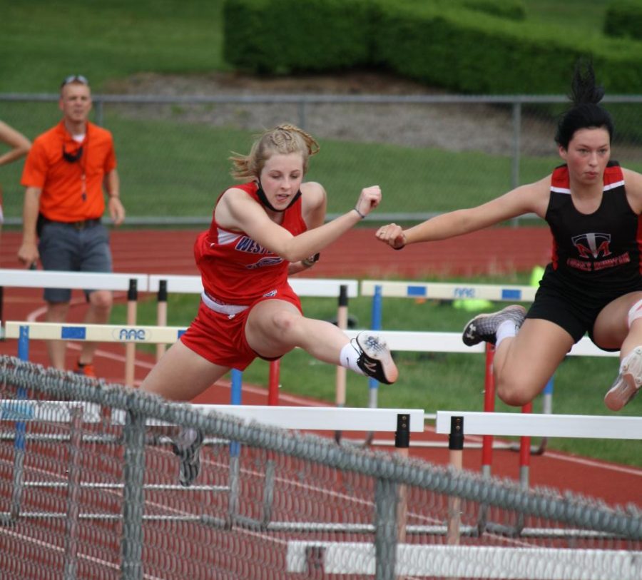 Emmie Parks leaps over the hurdle at the 2021 Tussey Mountain meet.