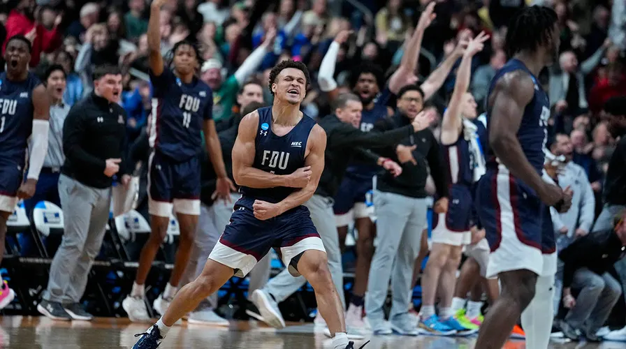 FDU+celebrates+their+unimaginable+first-round+victory+against+number+one-seeded+Purdue.
