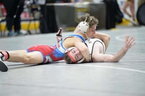 Landon Bainey puts his opponent on his back in the state tournament.