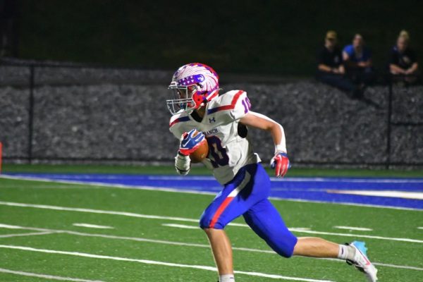 Male Athlete of the Week Coby Kephart running with the ball.