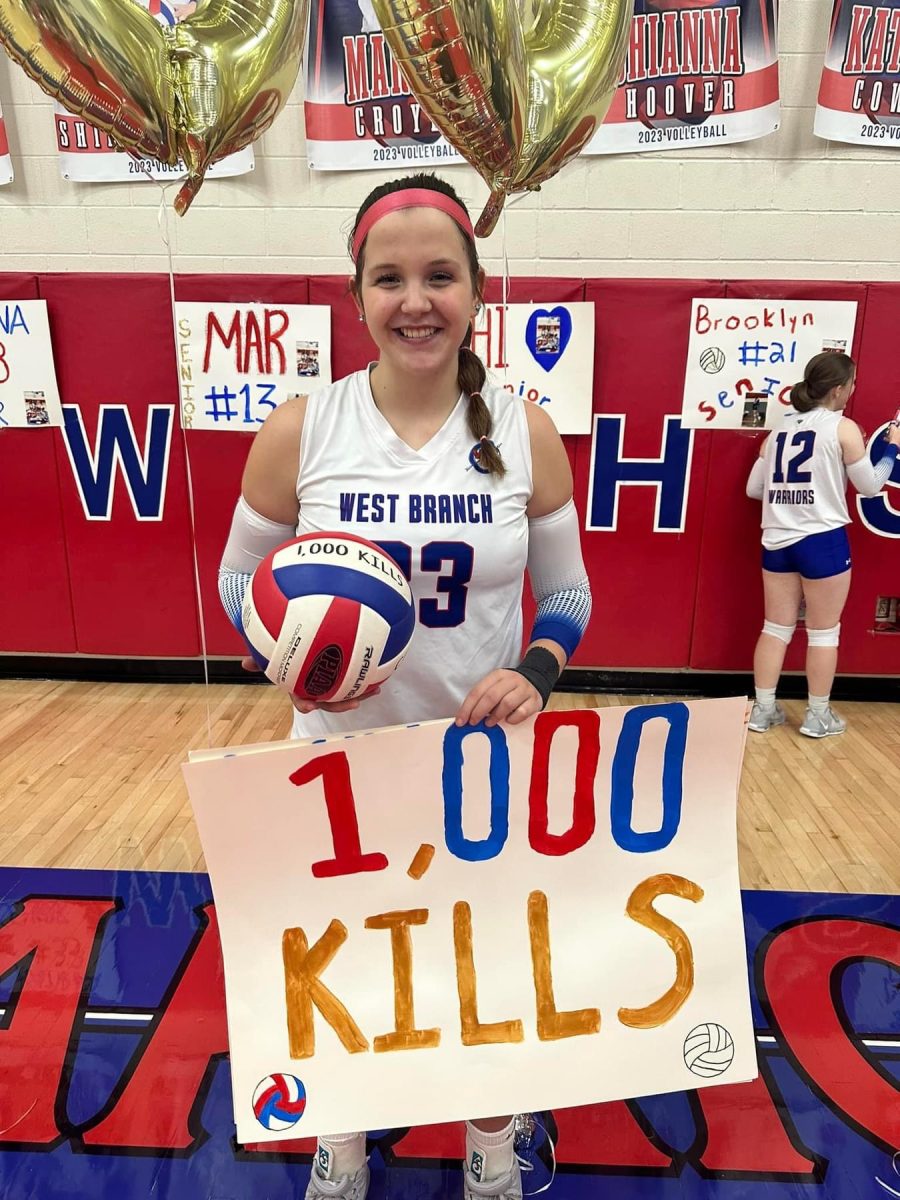 Katrina Cowder holds her ball after reaching 1000 kills and breaking the school record. 
