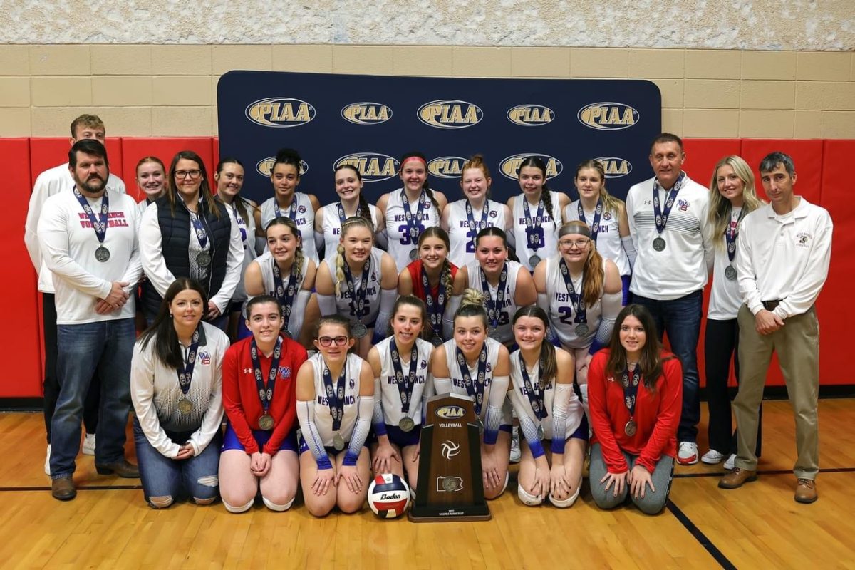 The+Warrior+volleyball+team+poses+with+their+PIAA+silver+medals+after+battling+against+Elk+County+Catholic.+
