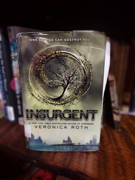 The second book of the Divergent trilogy, Insurgent by Veronica Roth. 