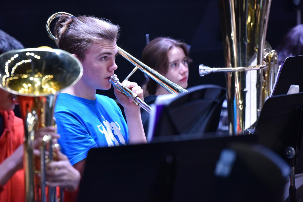 Keagan Dobo a trombone in the high school band playing at a rehearsal   