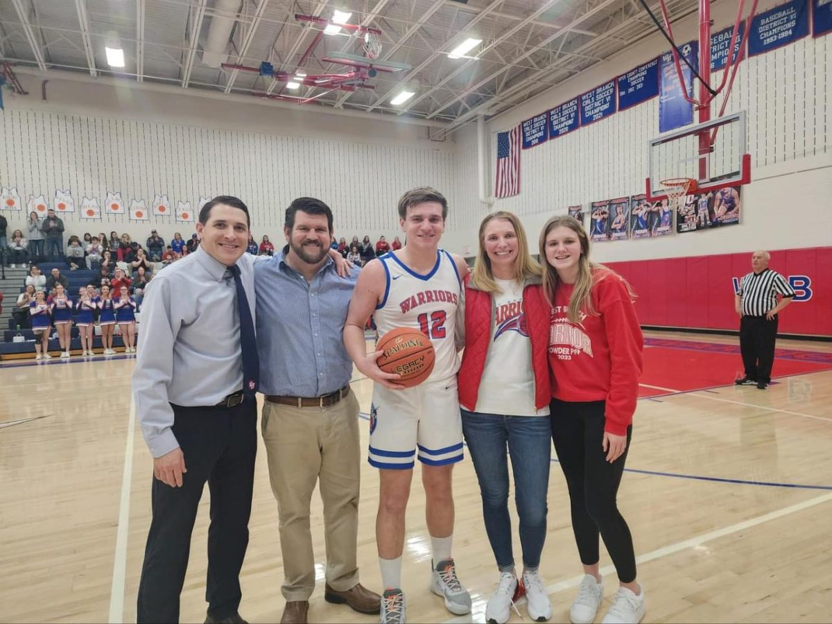 Owen Koleno takes a picture with his family and the game ball.
